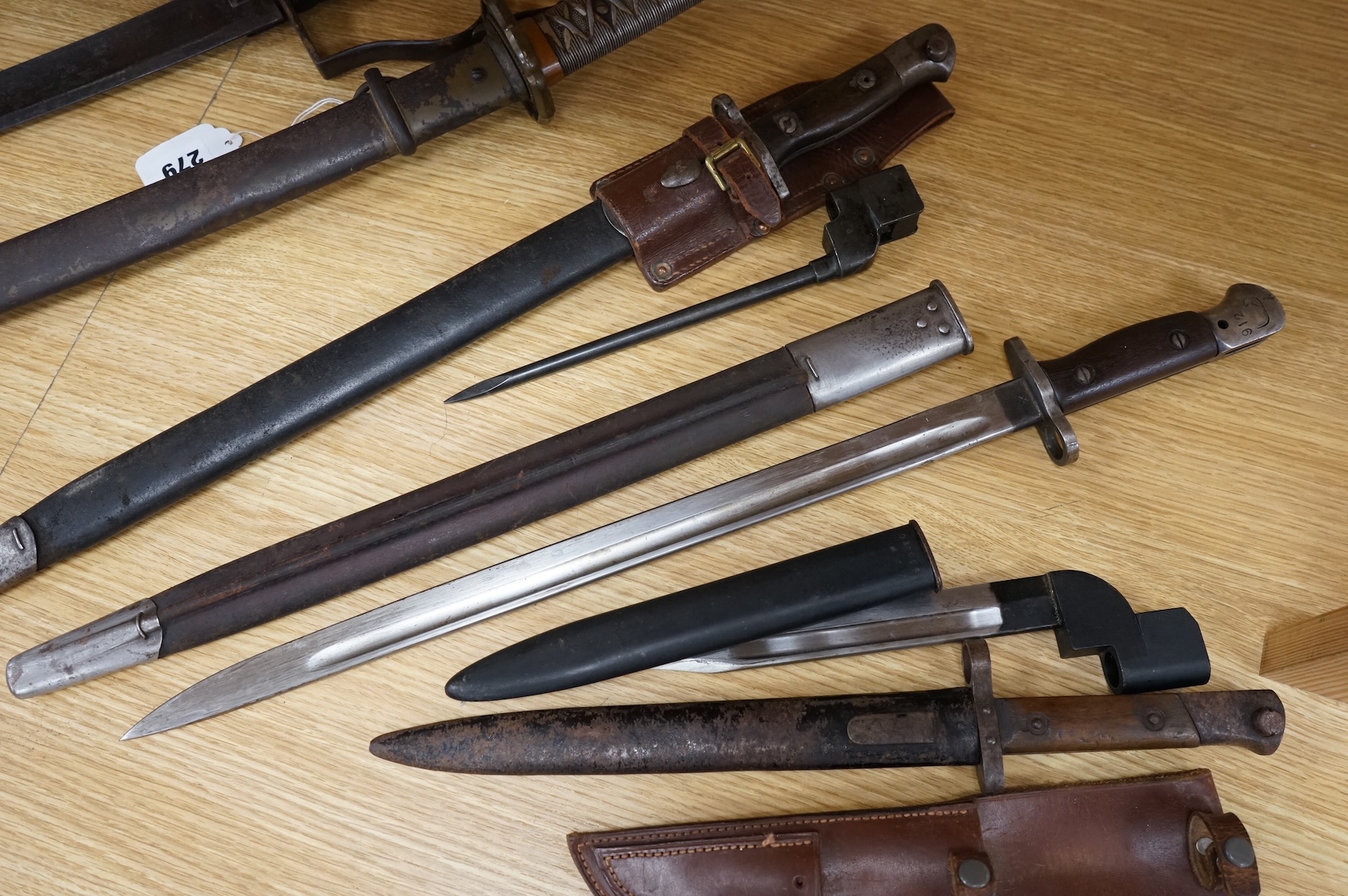 A 1907 bayonet by Wilkinson in its steel mounted leather scabbard, another similar with leather frog, two small British bayonets, a Continental bayonet, and two assorted hunting knives (7)